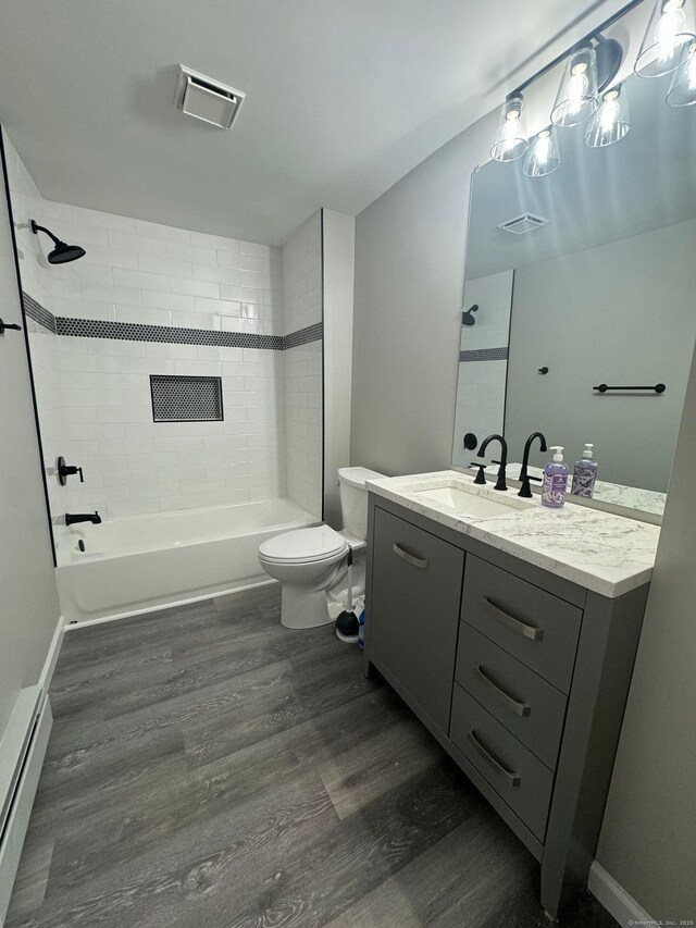 252-254 Liberty St, Meriden, CT 06450 - bathroom featuring toilet, wood finished floors, shower / tub combination, vanity, and a baseboard radiator