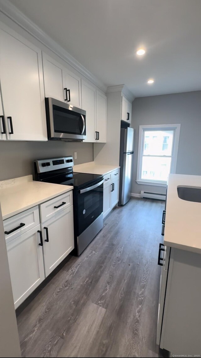 252-254 Liberty St, Meriden, CT 06450 - kitchen featuring stainless steel appliances, dark wood-type flooring, light countertops, white cabinetry, and recessed lighting