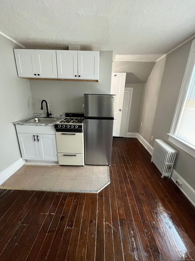 252-254 Liberty St, Meriden, CT 06450 - kitchen with freestanding refrigerator, gas range gas stove, radiator heating unit, a sink, and hardwood / wood-style flooring