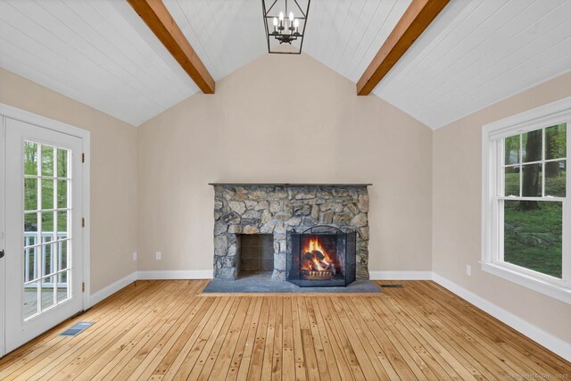 unfurnished living room with a chandelier, hardwood / wood-style flooring, a fireplace, and baseboards