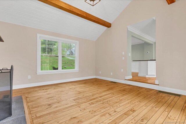 unfurnished living room featuring wood-type flooring and baseboards