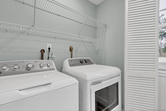 laundry area with washing machine and clothes dryer