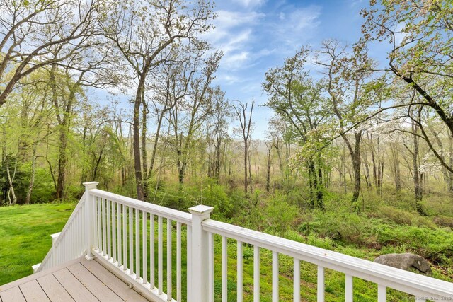 wooden deck with a lawn