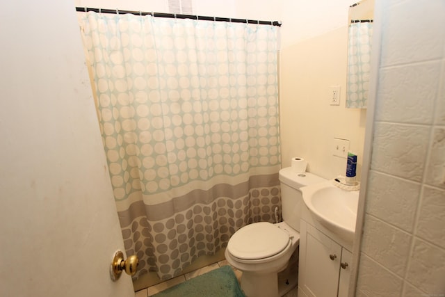 bathroom with toilet, vanity, and a shower with curtain