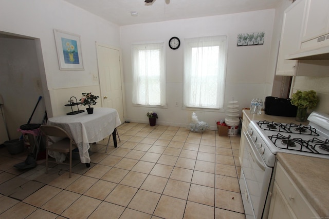 dining area with light tile patterned floors and a ceiling fan
