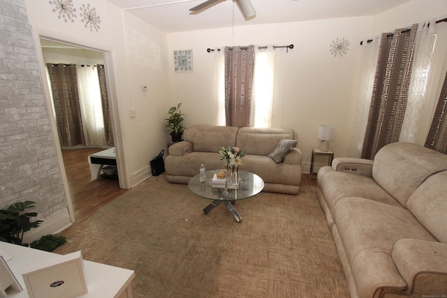 living area featuring a ceiling fan and wood finished floors