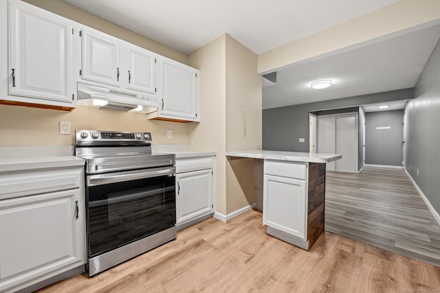 kitchen with stainless steel electric stove, under cabinet range hood, and light countertops