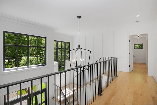 168 Proprietors Xing, New Canaan, CT 06840 - hall with a chandelier, an upstairs landing, crown molding, light wood finished floors, and baseboards