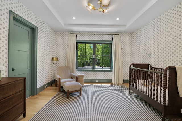 168 Proprietors Xing, New Canaan, CT 06840 - bedroom with light wood-type flooring, wallpapered walls, a tray ceiling, and a chandelier