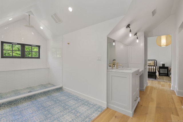 168 Proprietors Xing, New Canaan, CT 06840 - full bathroom featuring vaulted ceiling, vanity, wood finished floors, a tile shower, and baseboards