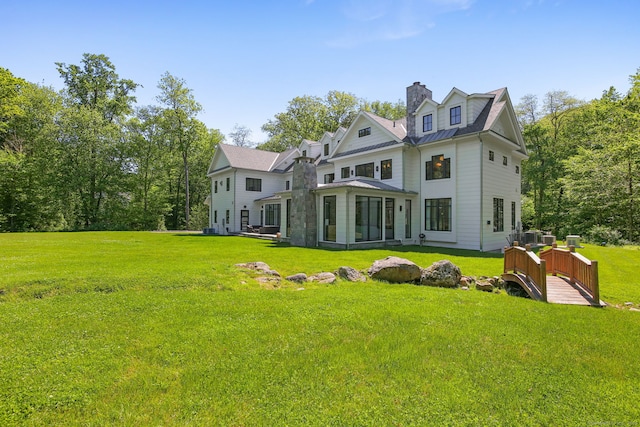 168 Proprietors Xing, New Canaan, CT 06840 - rear view of house featuring a standing seam roof, a chimney, metal roof, and a yard