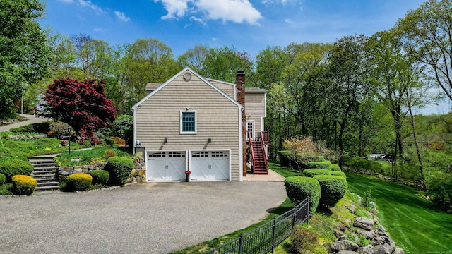 230 Ball Pond Rd, New Fairfield, CT 06812 - view of home's exterior with a chimney, fence, a garage, stairway, and aphalt driveway