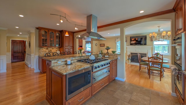230 Ball Pond Rd, New Fairfield, CT 06812 - kitchen featuring island exhaust hood, brown cabinets, stainless steel gas cooktop, a warming drawer, and built in microwave
