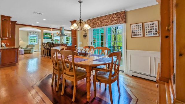 230 Ball Pond Rd, New Fairfield, CT 06812 - dining room featuring ornamental molding, visible vents, baseboard heating, wainscoting, and light wood-style floors
