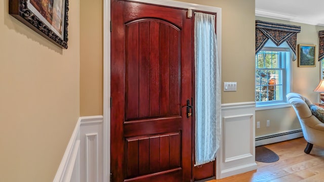 230 Ball Pond Rd, New Fairfield, CT 06812 - entryway featuring ornamental molding, baseboard heating, and wood finished floors