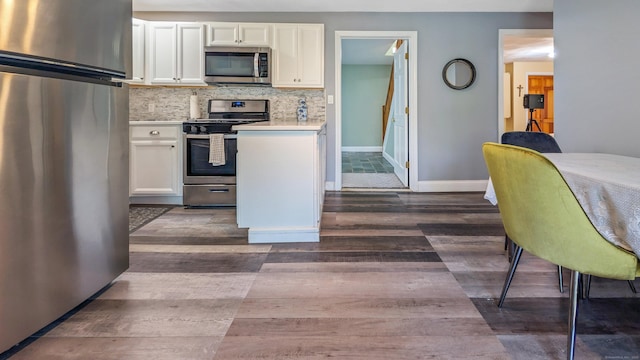 230 Ball Pond Rd, New Fairfield, CT 06812 - kitchen featuring baseboards, white cabinetry, dark wood-type flooring, light countertops, and appliances with stainless steel finishes