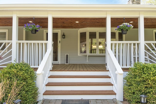 view of exterior entry with a porch