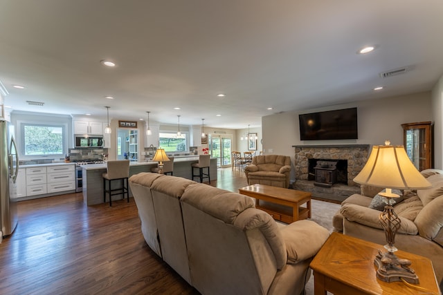 living room with dark wood-type flooring and recessed lighting