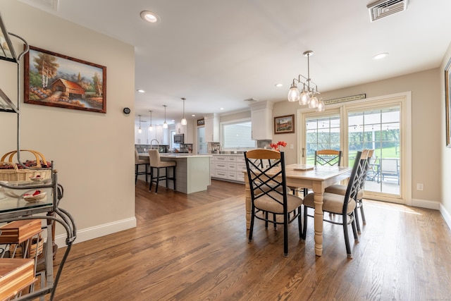 dining area with baseboards, recessed lighting, and wood finished floors