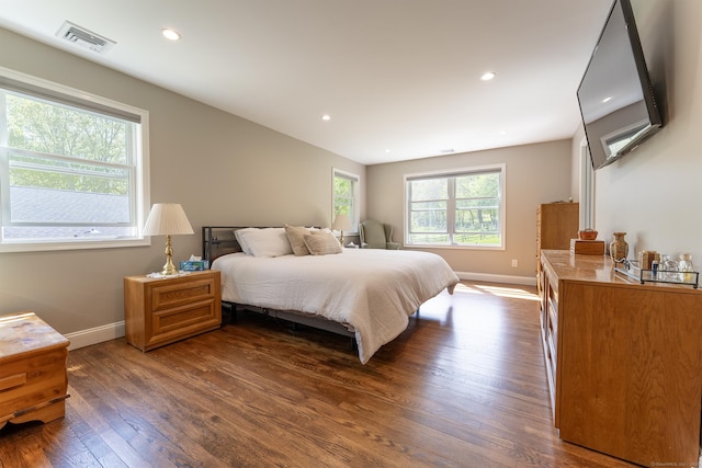 bedroom with baseboards, dark wood-type flooring, and recessed lighting