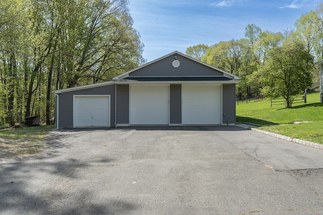detached garage featuring fence