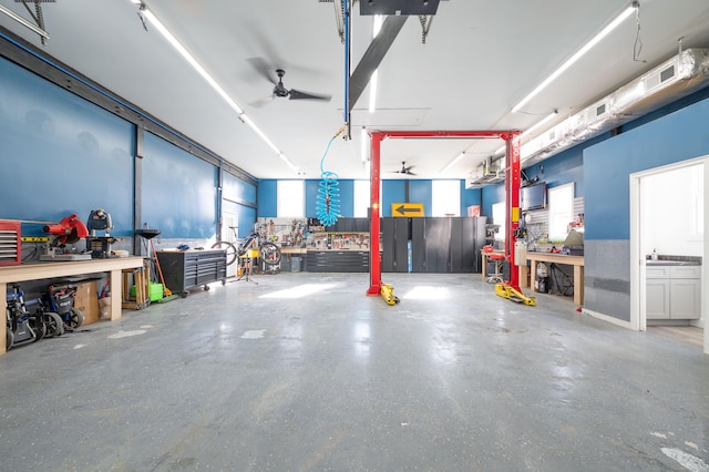 garage featuring a workshop area, visible vents, and a ceiling fan