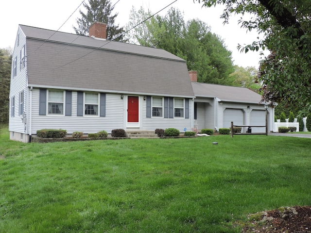 dutch colonial featuring a chimney, a front lawn, and a garage