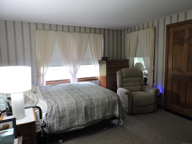 bedroom featuring carpet and wallpapered walls