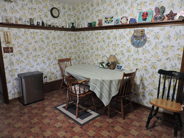 dining area with baseboards and wallpapered walls