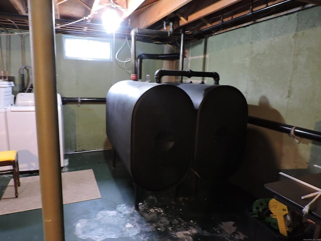 below grade area featuring heating fuel and washing machine and clothes dryer