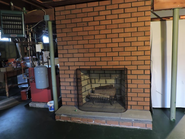 interior details with finished concrete flooring and a brick fireplace
