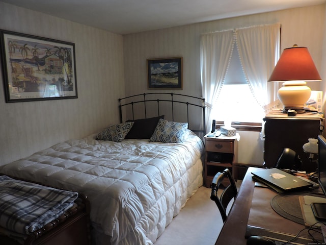carpeted bedroom featuring wallpapered walls