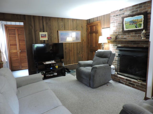 living room featuring carpet flooring, wood walls, baseboard heating, and a brick fireplace