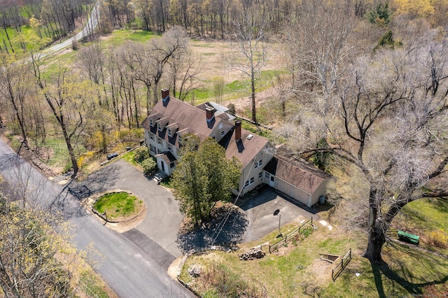 aerial view of property and surrounding area with a forest