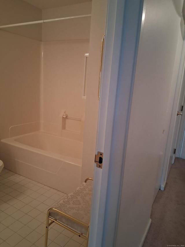 bathroom with toilet,  shower combination, and tile patterned floors
