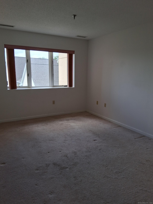 empty room with baseboards and light carpet