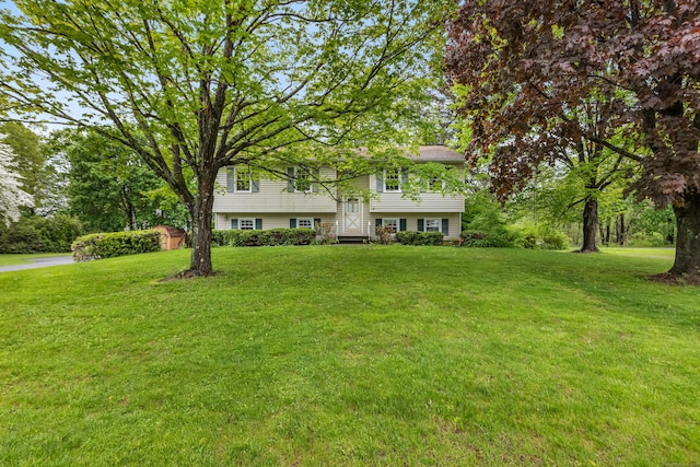 raised ranch featuring a front lawn