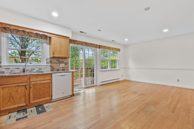 kitchen with white dishwasher, a baseboard heating unit, a sink, light wood finished floors, and recessed lighting