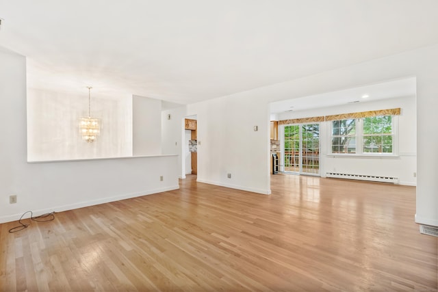 unfurnished living room with a baseboard radiator, light wood-style flooring, a chandelier, and baseboards