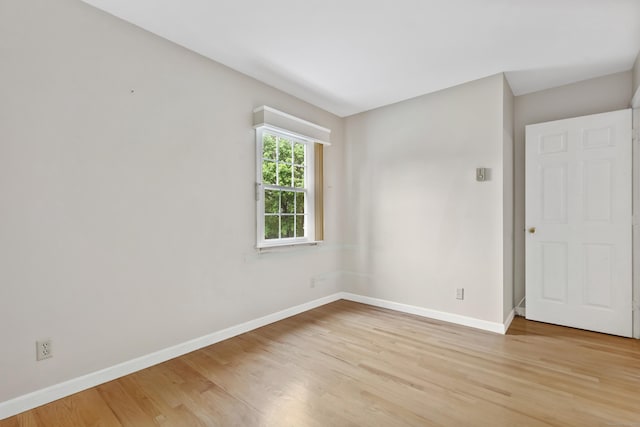 unfurnished room featuring light wood-style floors and baseboards