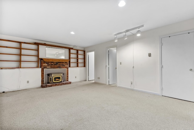unfurnished living room featuring light colored carpet, a fireplace, and recessed lighting