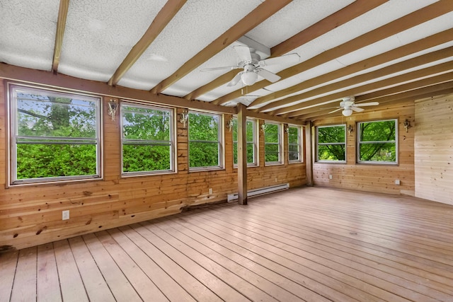 unfurnished sunroom featuring a baseboard radiator, wood walls, hardwood / wood-style floors, and beamed ceiling