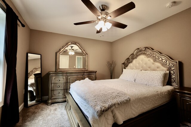bedroom with light carpet, baseboards, and ceiling fan