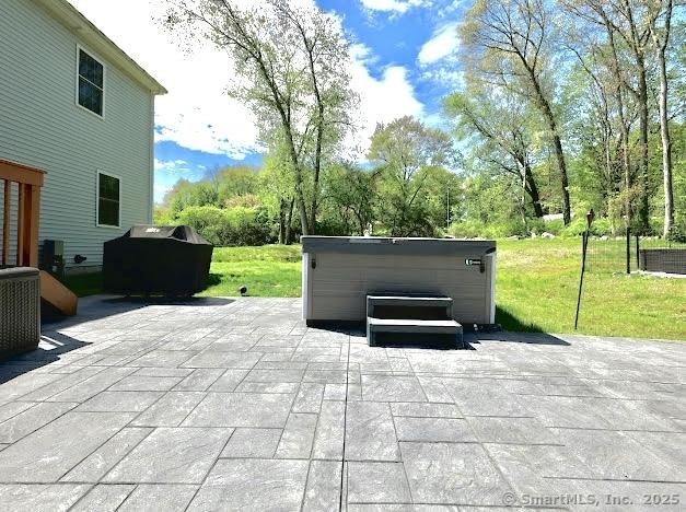 view of patio / terrace featuring a hot tub and cooling unit