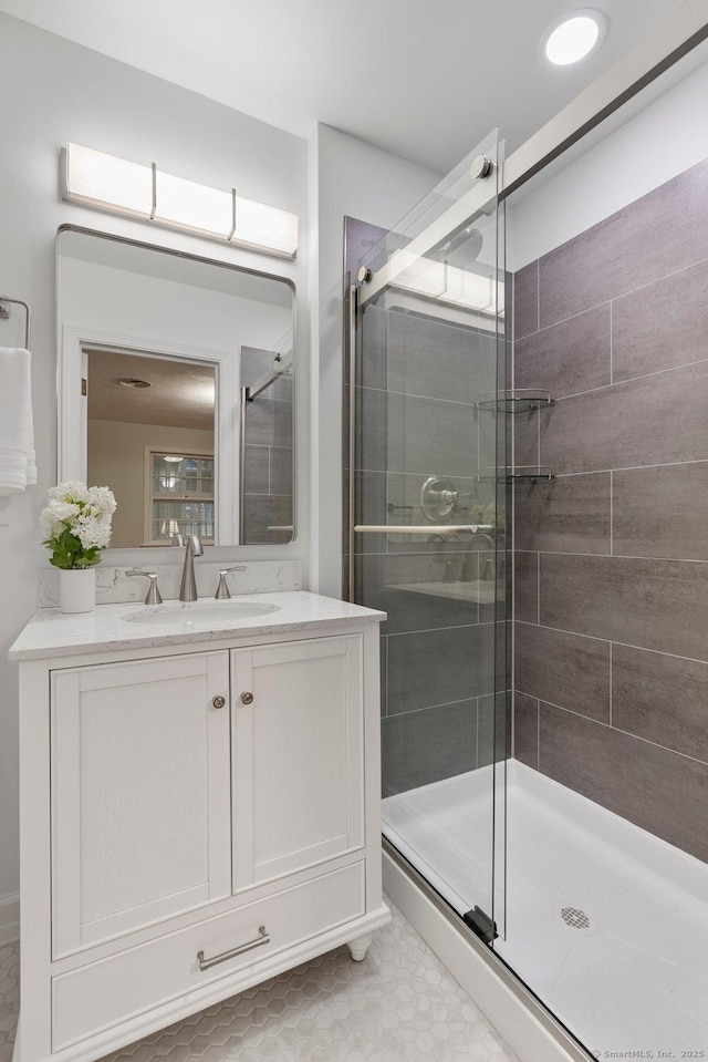 bathroom with a stall shower and vanity