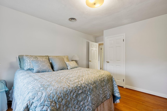 bedroom featuring wood finished floors and baseboards
