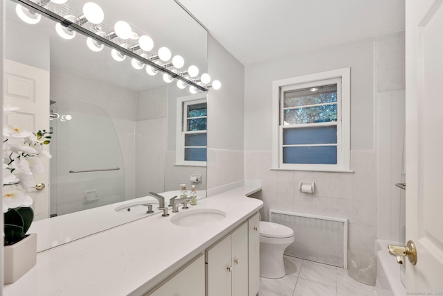 full bath featuring tile walls, toilet, vanity, a shower, and tile patterned flooring