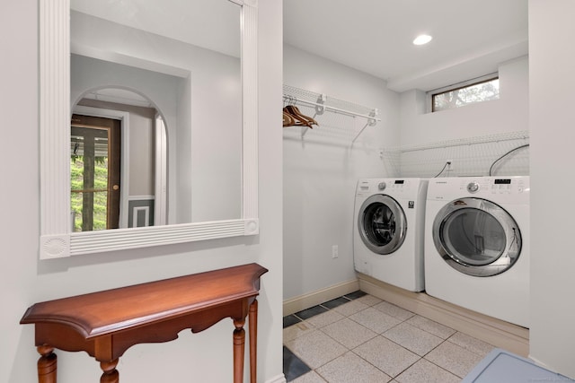 laundry room featuring washer and clothes dryer, recessed lighting, baseboards, plenty of natural light, and arched walkways
