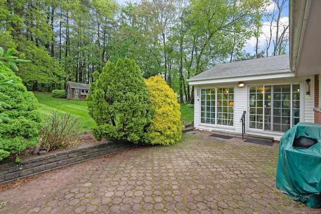 view of patio with an outdoor structure and area for grilling