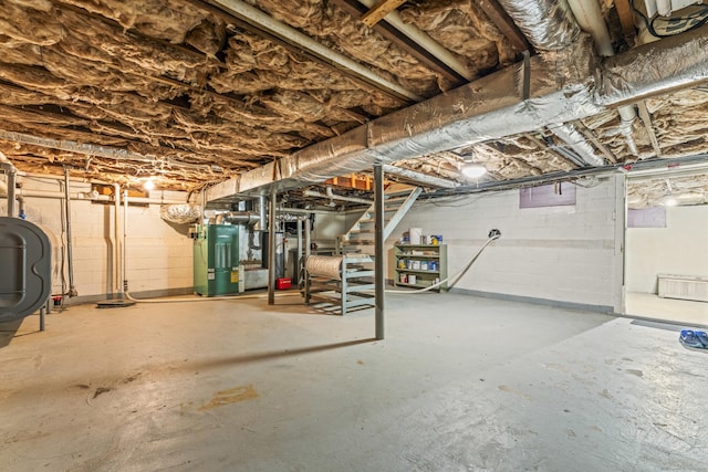 unfinished basement featuring stairs, heating fuel, and heating unit
